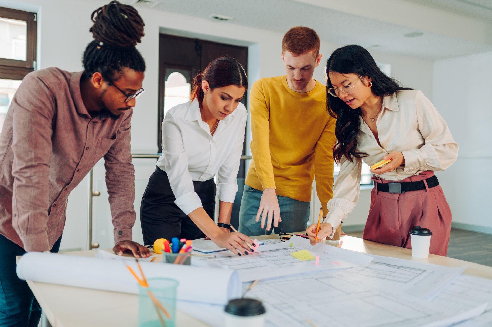 Multiracial team of engineers or architects having a meeting in an office